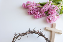 Pink hyacinth flowers with cross and crown of thorns on a white background