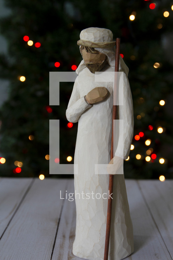 Joseph figurine near a Christmas tree 