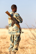 a soldier carrying a rifle 