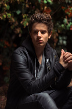 teen boy in a leather jacket and hoodie 