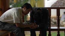 Two Men Praying Together And Encouraging Each Other Wide