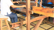 Weaving fabric on a traditional loom.