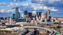 Aerial Panning Shot of Interstate 35 East Traffic and Downtown Dallas Texas Skyline	