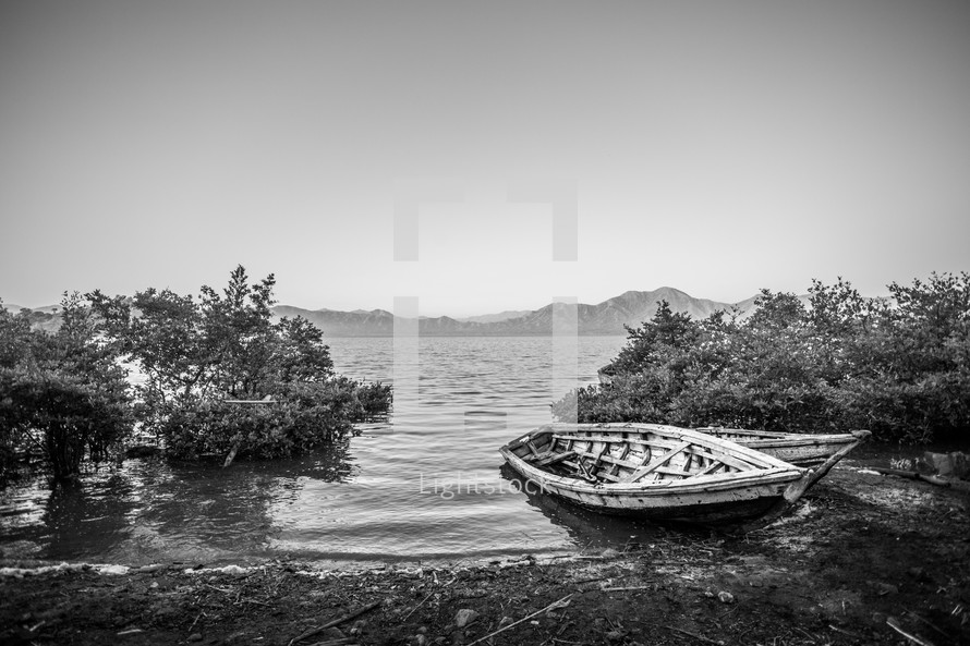 Boats in the bay.  Mountains and ocean in the back ground- Haiti