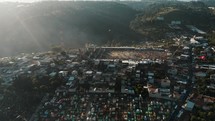 Aerial Drone Shot of Crowds At The Football Field Near The Cemetery Of Sumpango During The Kite Festival Celebration In Guatemala. 