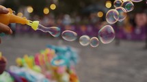 Vendor Making Soap Bubbles From A Toy In The Street. - close up