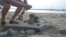 Man builds Inukshuk on beach- sped up