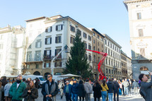 Florence, Italy - December 03, 2023: Christmas tree installation in the central square of Florence. Workers on lifting platforms mount the Christmas lights.