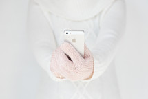 woman in gloves holding a cellphone 