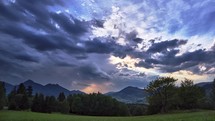 storm clouds at dusk in a beautiful mountain landscapeAutumn landscape with meadows and trees and mountains.