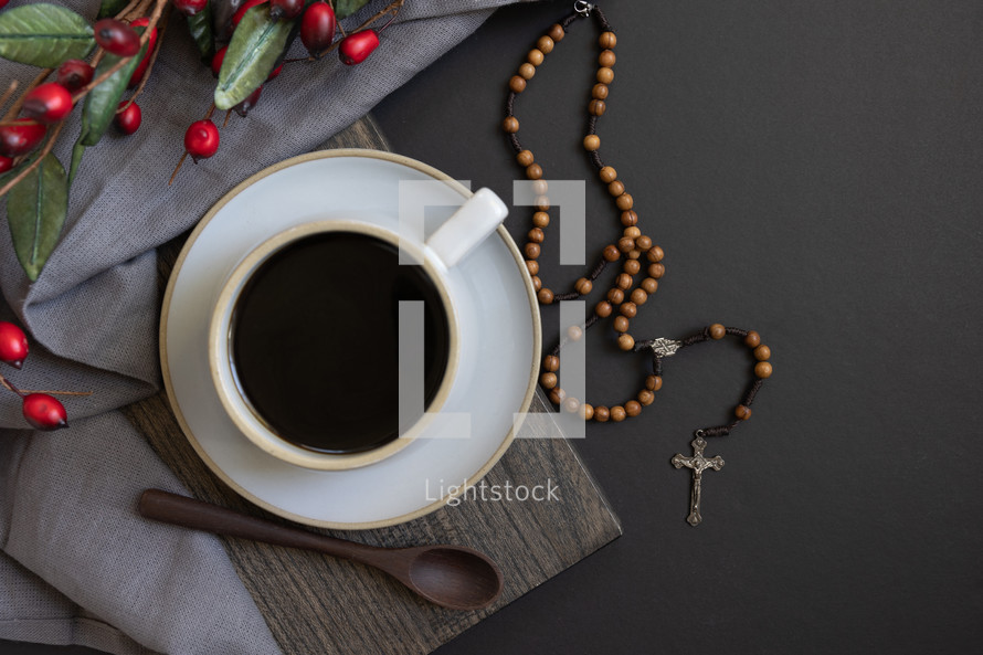 coffee and red berries, with rosary, from above