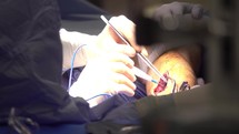 Surgeon conducting surgery on patient leg
