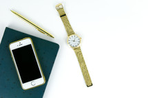 watch, pen, and notebook on white background 