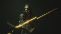 Rock Musician Playing Electric Guitar in Dark Room with Light Beam