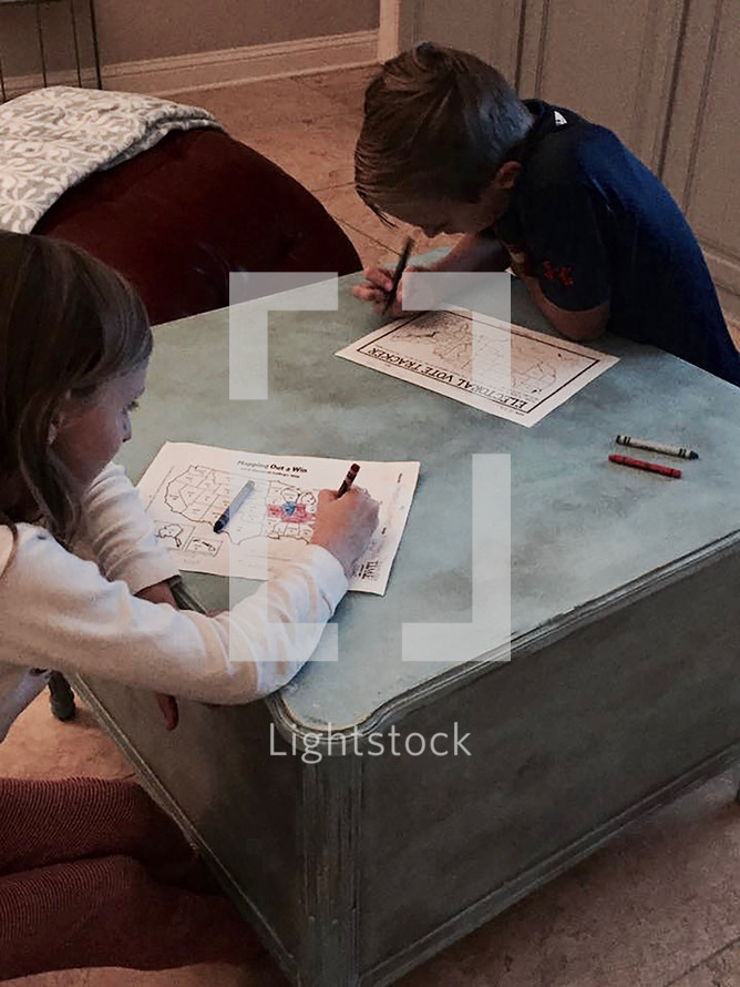 children watching election results on election night and coloring a political map of the United States red or blue 