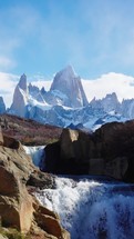 Mount Fitz Roy showing though secret waterfall in Patagonia Argentina, El Chalten town. Vertical shot
