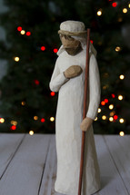 Joseph figurine near a Christmas tree 