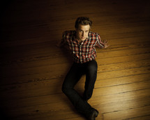 man sitting on a wood floor