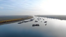 Aerial View Of Danube River With Floating Pontoons At Sunset In Galati, Romania. drone shot