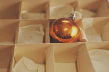 One lonely Christmas ornament in it's box.