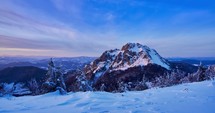 Colorful winter rocky mountain in beautiful wild snowy nature at sunset, time lapse video