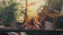 Brick BBQ alight, burning wood barbecue, camp fire outdoor cooking video	
