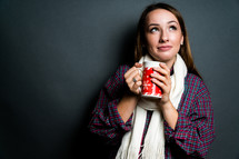a young woman holding a mug 