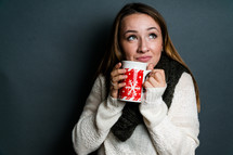 Young woman holding winter mug 