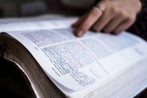 reading a Bible with notes in it 