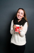a teen girl holding a winter mug with tea 