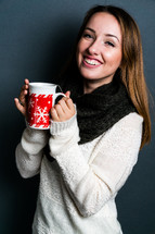 a teen girl holding a mug of hot cocoa 