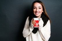 teen girl holding a mug with hot tea 
