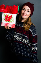 a teen girl holding a Christmas gift 