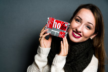 a teen girl holding a Christmas gift 