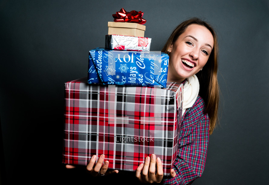 teen girl holding Christmas gifts 