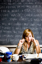 student in front of a chalkboard with rules cramming for a test