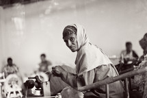 woman sewing at a sewing machine in a factory