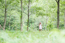 woman standing in a forest 