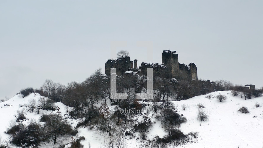 Medieval citadel on a hill in winter - low angle
