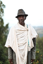 man wearing a hat and blanket