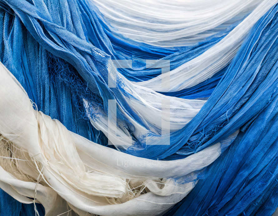draped blue and white loosely woven fabrics
