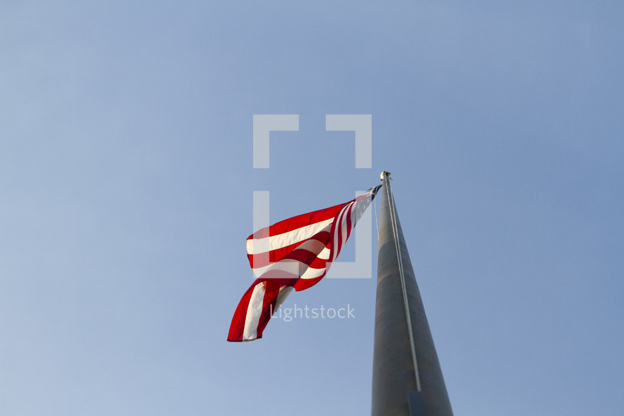looking up at an American flag 