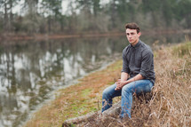 portrait of a young man near a lake 
