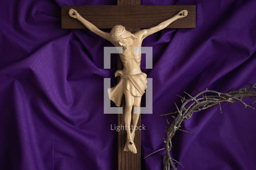 Crucifix and crown of thorns on a purple cloth