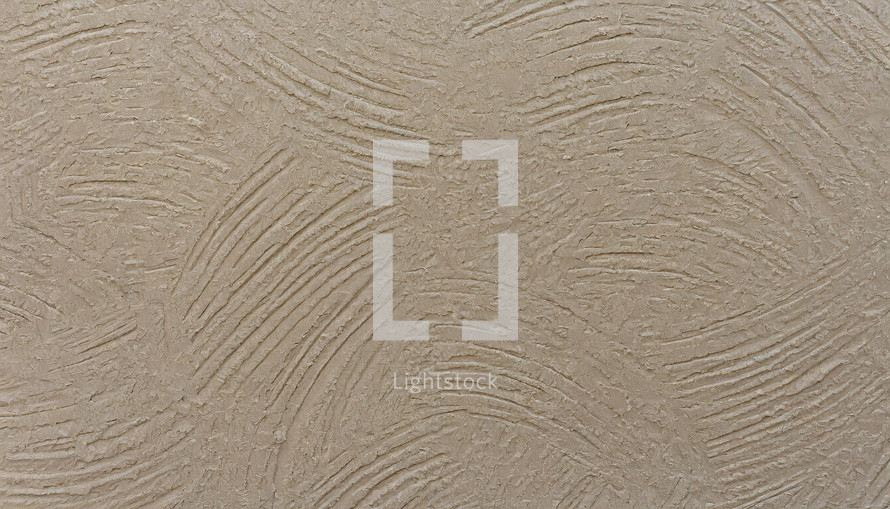 rough background surface in beige with curved, scraped lines