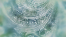 soft blue, green and white swirl effect abstract background like part of a seashell closeup