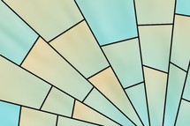 radiating stained glass design in aqua to pale orange with black leading effect