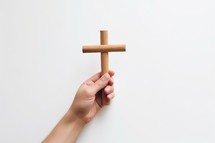 Hand Holding a Wooden Cross Isolated on White Background