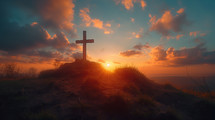 Cross on a hill at sunset with clouds on blue sky . Easter, resurrection, new life, redemption concept. 