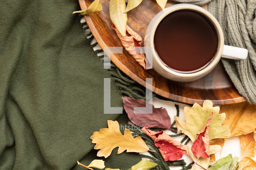 mug, fall leaves on a green scarf 
